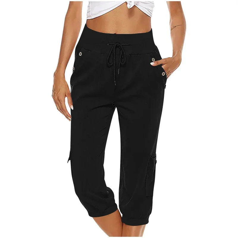 Woman wearing black cropped cargo pants with drawstring waist and button details
