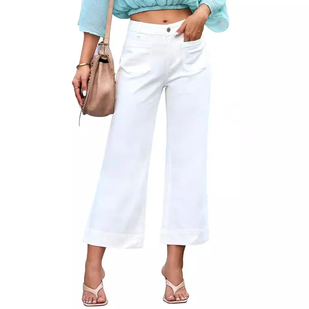 Woman wearing white wide-leg cropped pants with cuffed hems and light blue cropped top