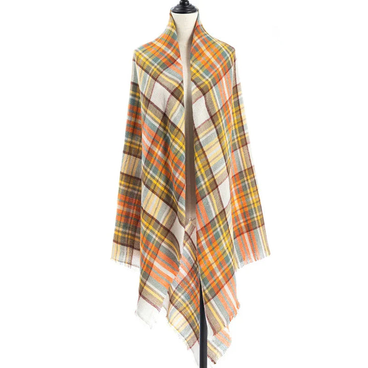 Plaid shawl wrap with orange, yellow, green, and brown stripes displayed on a white mannequin