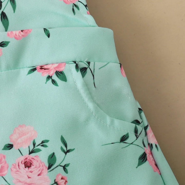 Close-up of mint green fabric pocket with pink floral pattern on beige background