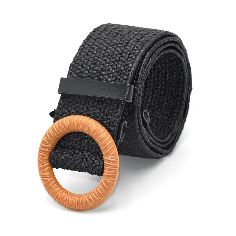 Black woven belt with tan circular buckle on white background