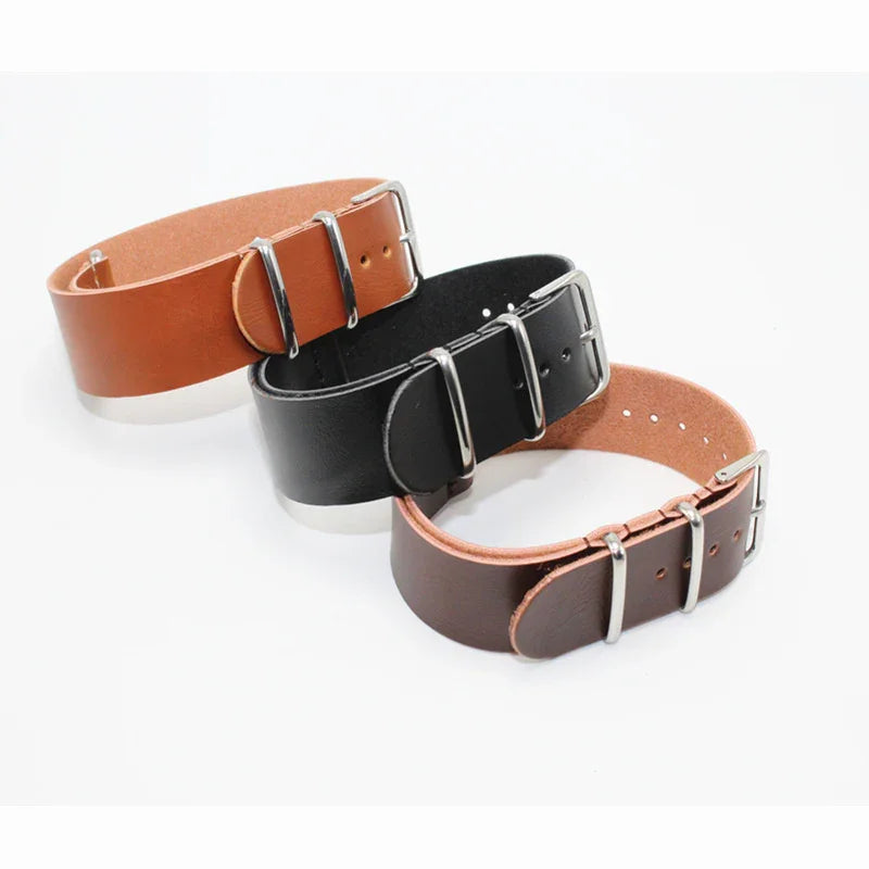 Three leather watch straps in tan, black, and brown with silver buckles on white background