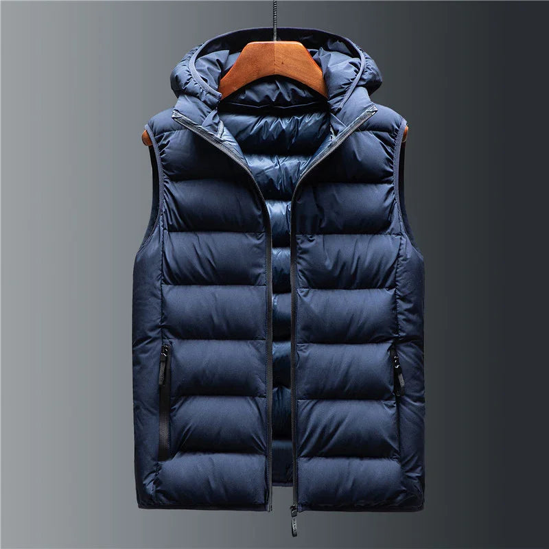 Navy blue padded sleeveless puffer vest with hood and front zipper on wooden hanger