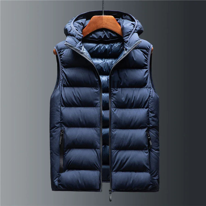 Navy blue padded sleeveless puffer vest with hood and front zipper on wooden hanger
