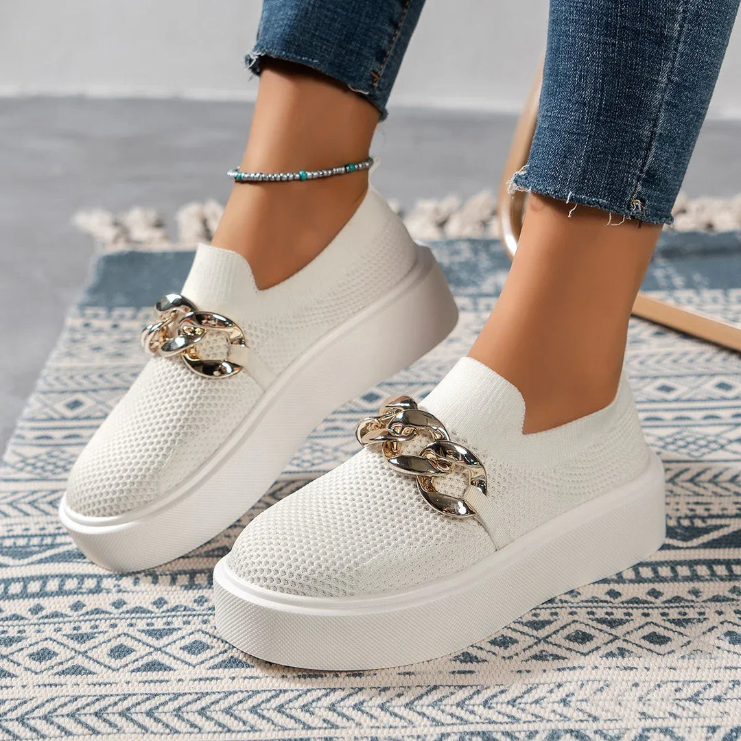 White platform slip-on shoes with gold chain detail worn with cropped denim jeans and turquoise anklet