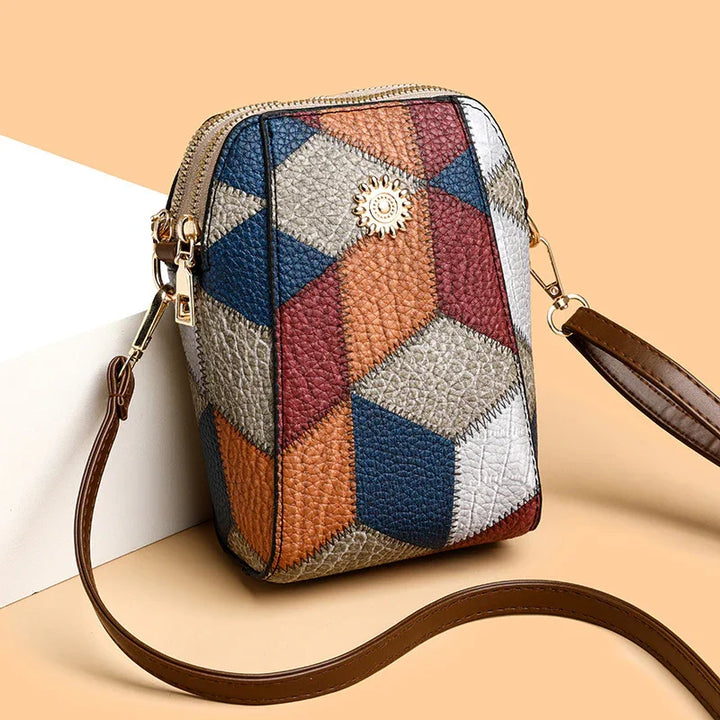 Colorful geometric pattern crossbody leather bag with gold emblem and brown strap