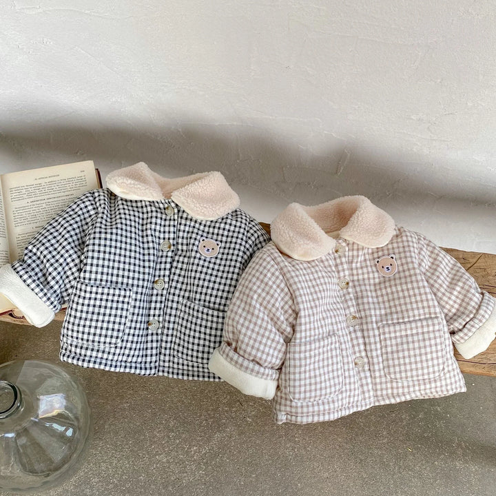 Two toddler checkered jackets in black and beige with sherpa collars and bear patches