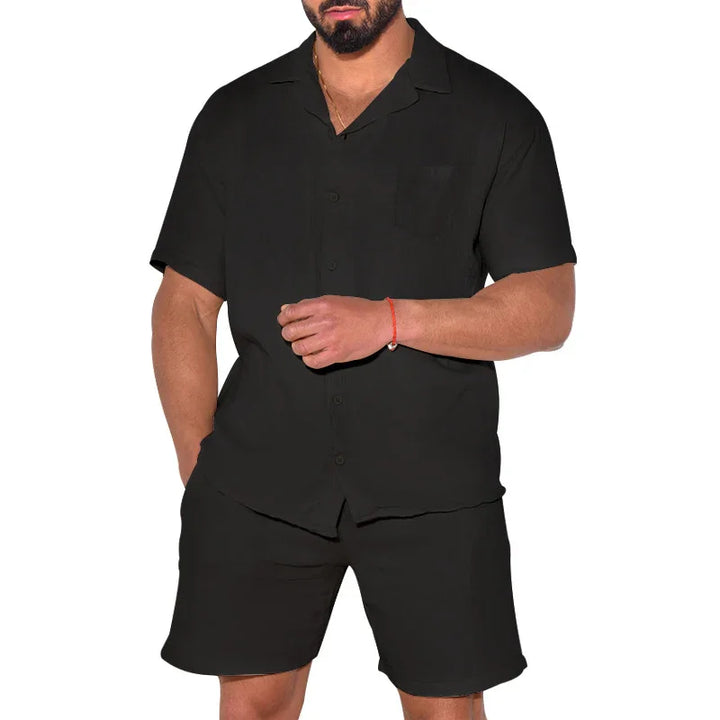 man wearing black short sleeve button-up shirt and matching black shorts with red bracelet