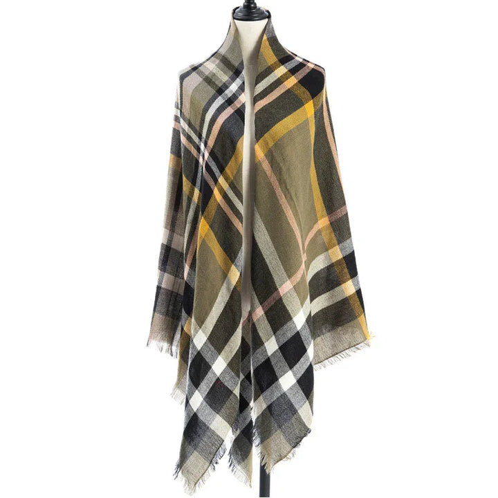 Plaid checkered scarf in mustard, olive, black, and white displayed on mannequin