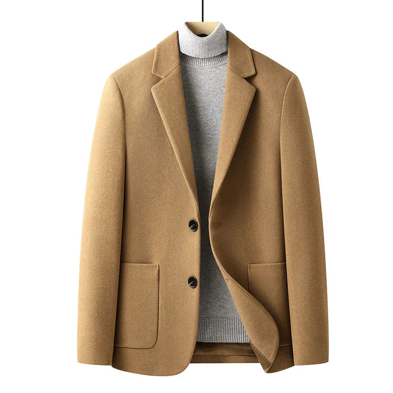 camel wool blend blazer with black buttons layered over grey turtleneck sweater on wooden hanger