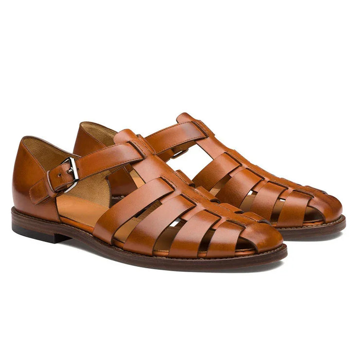 Pair of brown leather men's fisherman sandals with buckle straps and flat soles