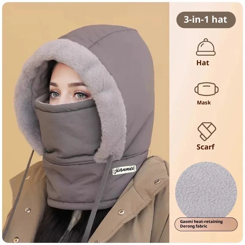 Woman wearing a gray 3-in-1 winter hat with faux fur trim, covering head, mask, and scarf for warmth