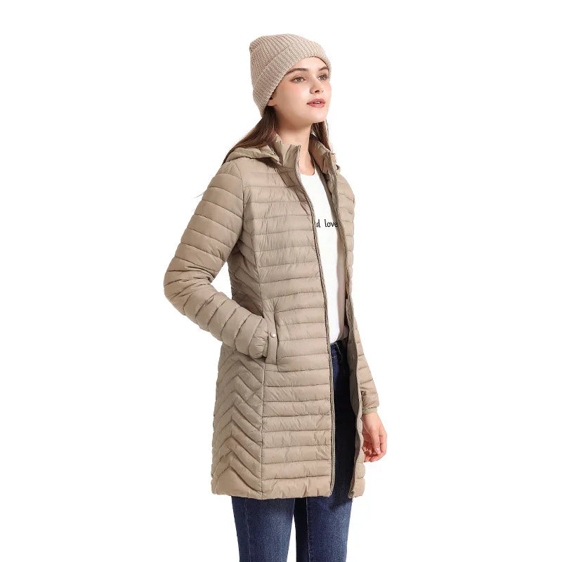 Woman wearing beige long quilted winter jacket with hood and matching knit beanie