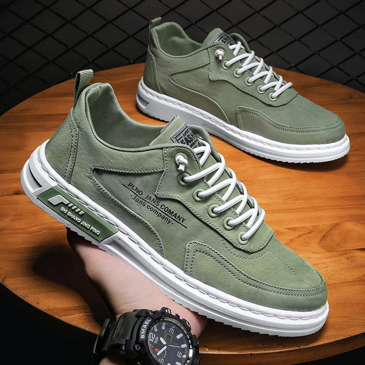 Green casual sneakers with white soles and laces on wooden surface, featuring branding and modern design