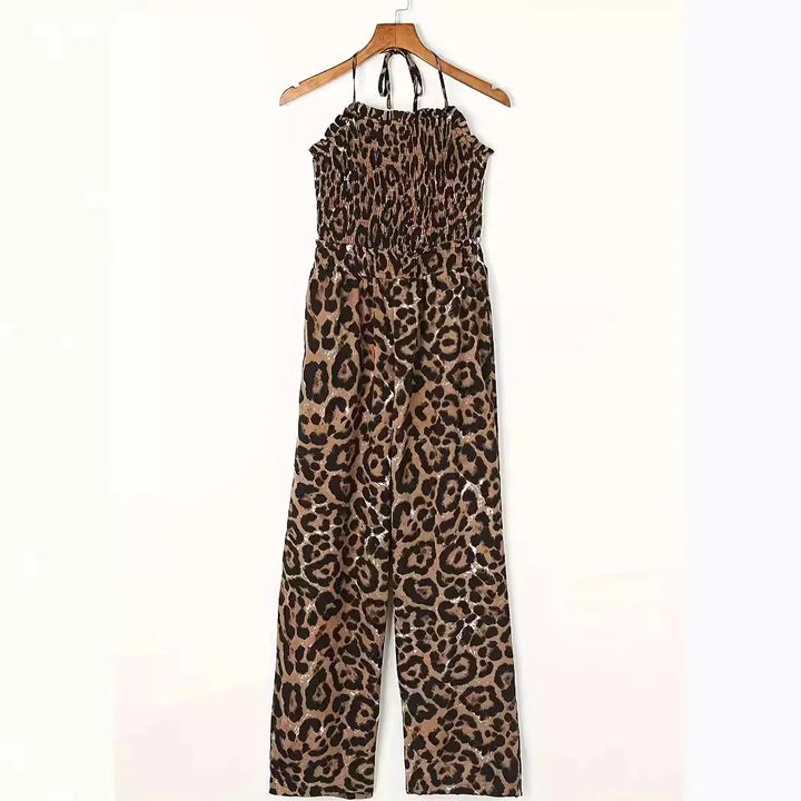 leopard print sleeveless halter jumpsuit with smocked bodice on wooden hanger