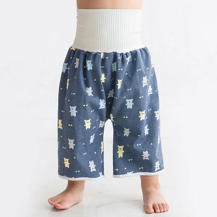 Baby wearing blue cotton pants with cartoon animal prints and wide white waistband on white background