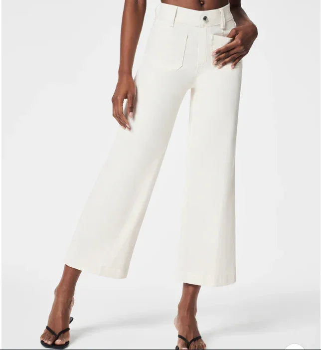 Woman wearing high-waisted white wide-leg cropped pants with front pockets and black heeled sandals