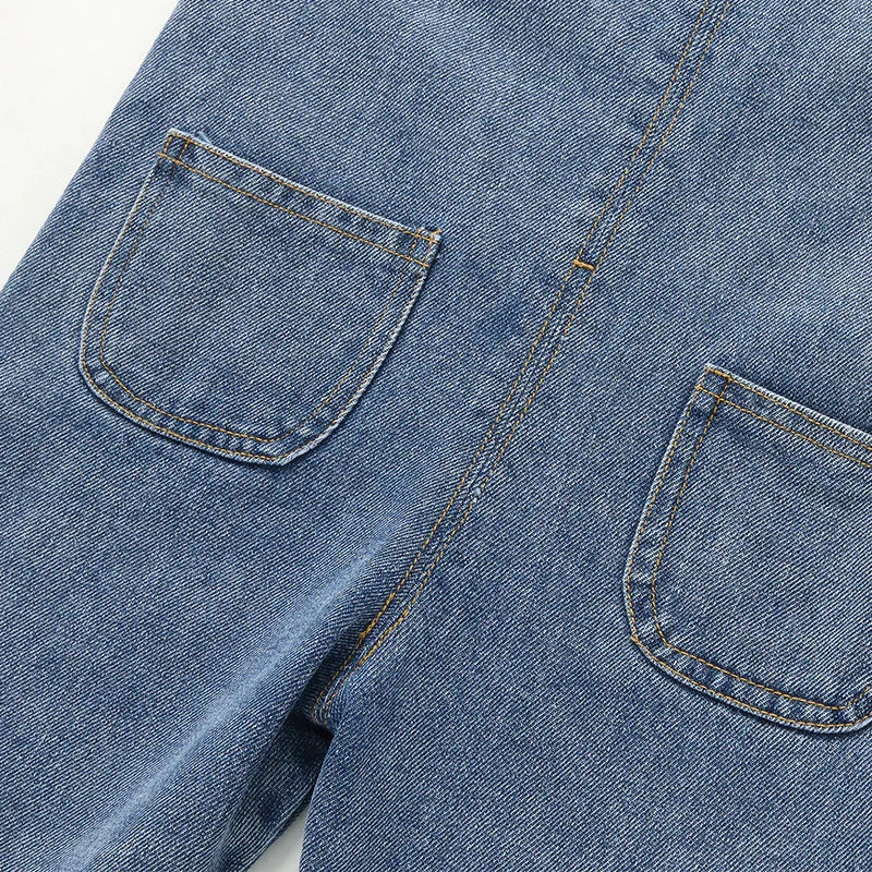 Close-up of blue denim jeans with two back pockets and detailed orange stitching