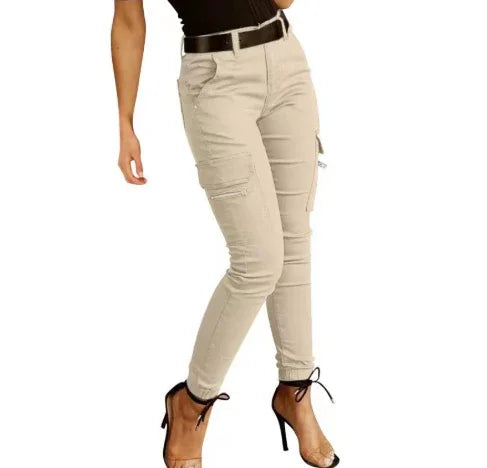 woman wearing beige cargo pants with black belt and black high heel sandals on white background