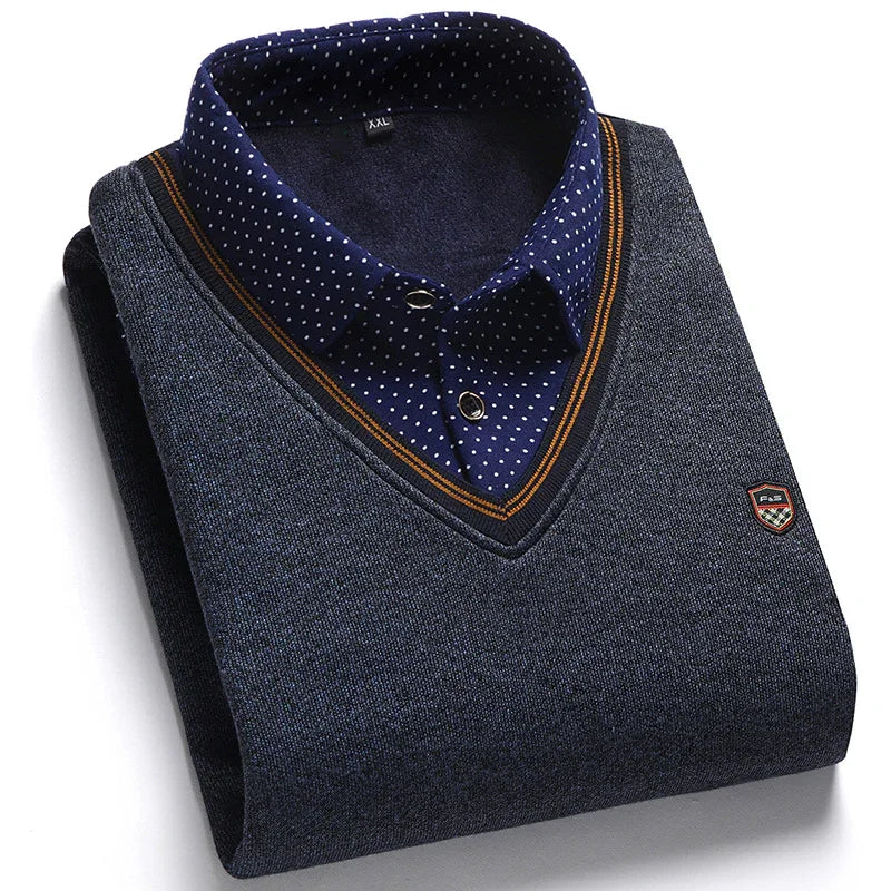 Folded navy blue V-neck sweater with brown trim over a navy blue polka dot shirt, men's fashion