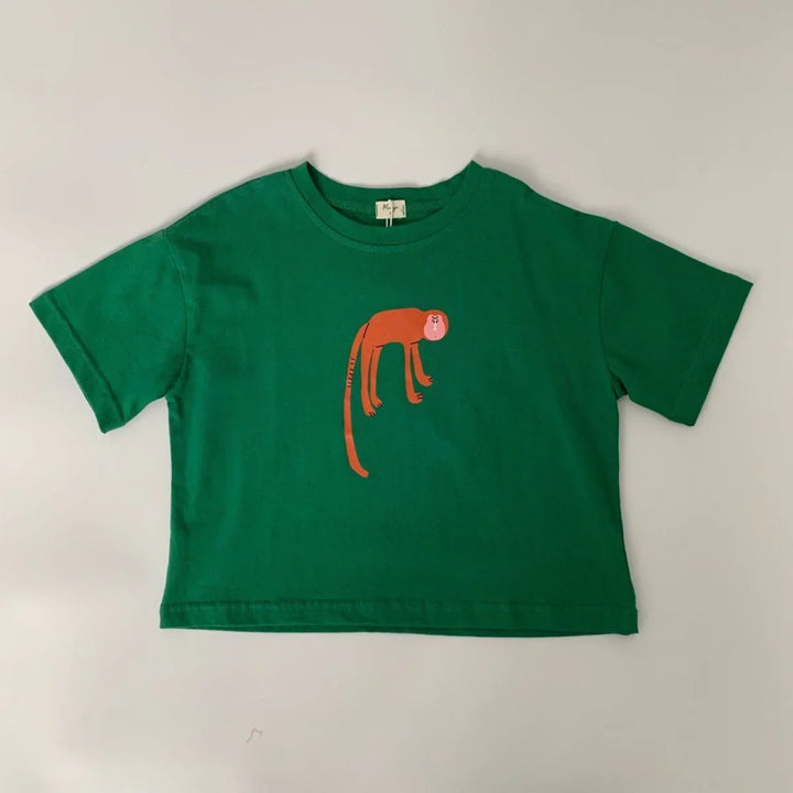 Green short-sleeve t-shirt with a minimalist orange monkey graphic on front