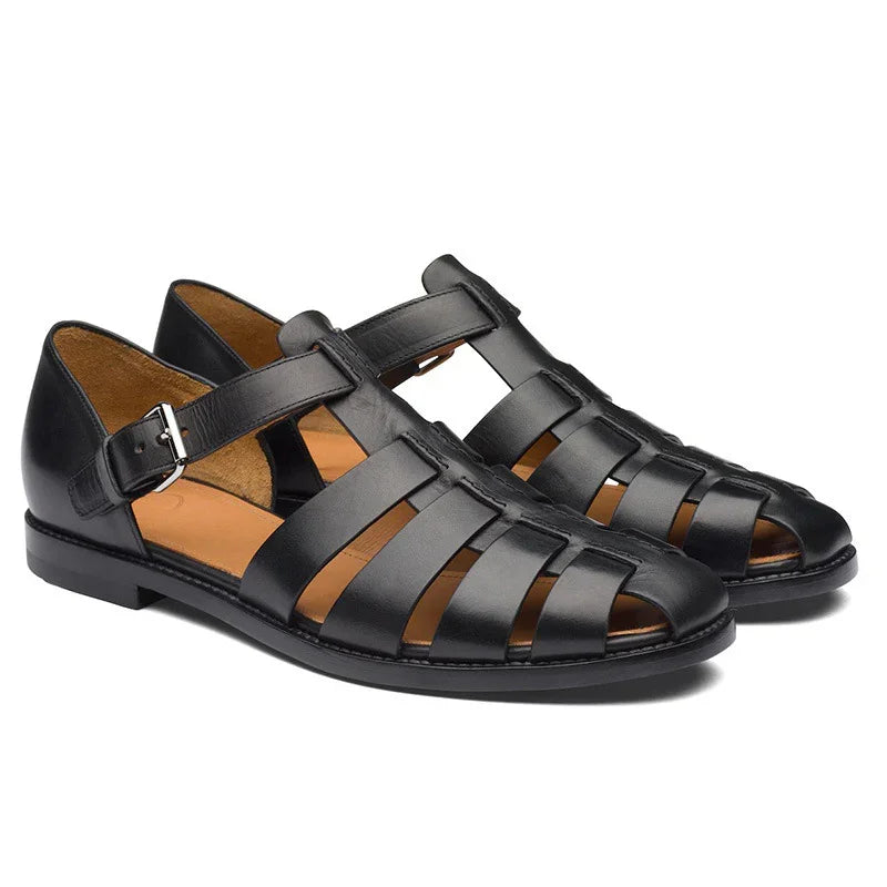 Pair of black leather fisherman sandals with buckle strap and tan leather insole