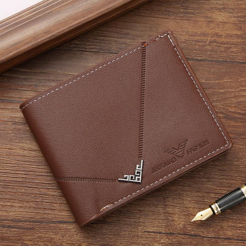 Brown leather men's wallet with decorative stitching and metal corner detail on wooden surface