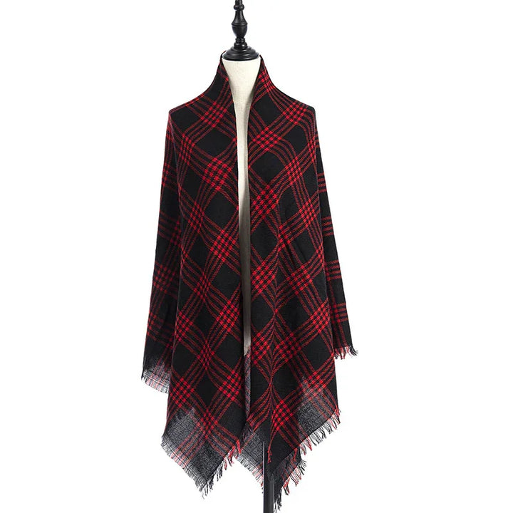 Black and red plaid wool scarf with fringed edges displayed on mannequin