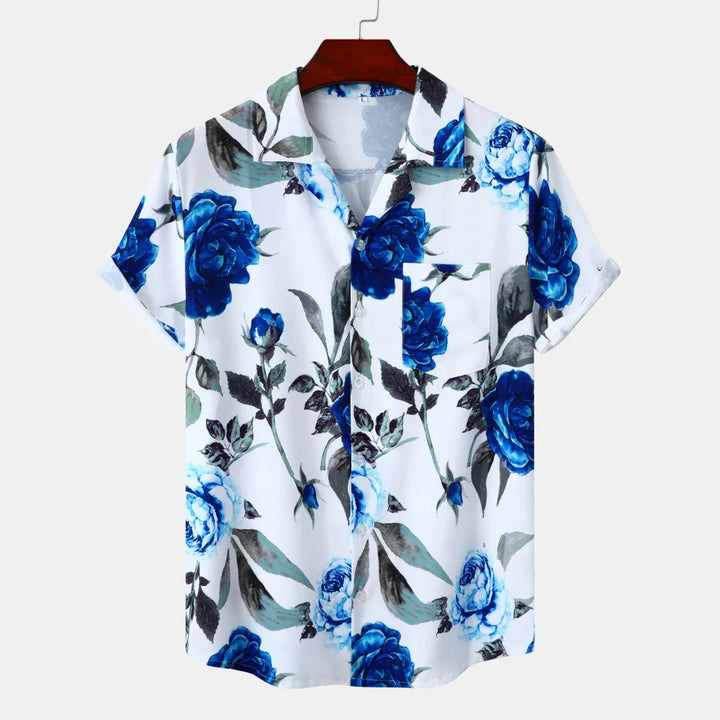 white short sleeve button-up shirt with blue floral print and green leaves on hanger