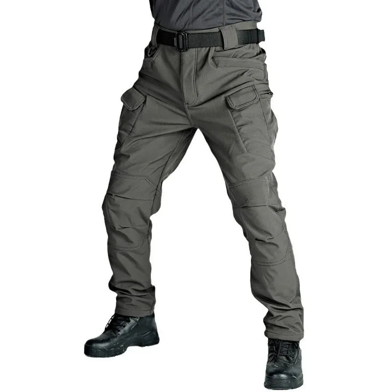 Men's tactical grey cargo pants with multiple pockets and black belt, worn with black boots