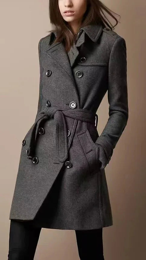 Woman wearing a stylish dark gray double-breasted belted wool coat with buttons and pockets