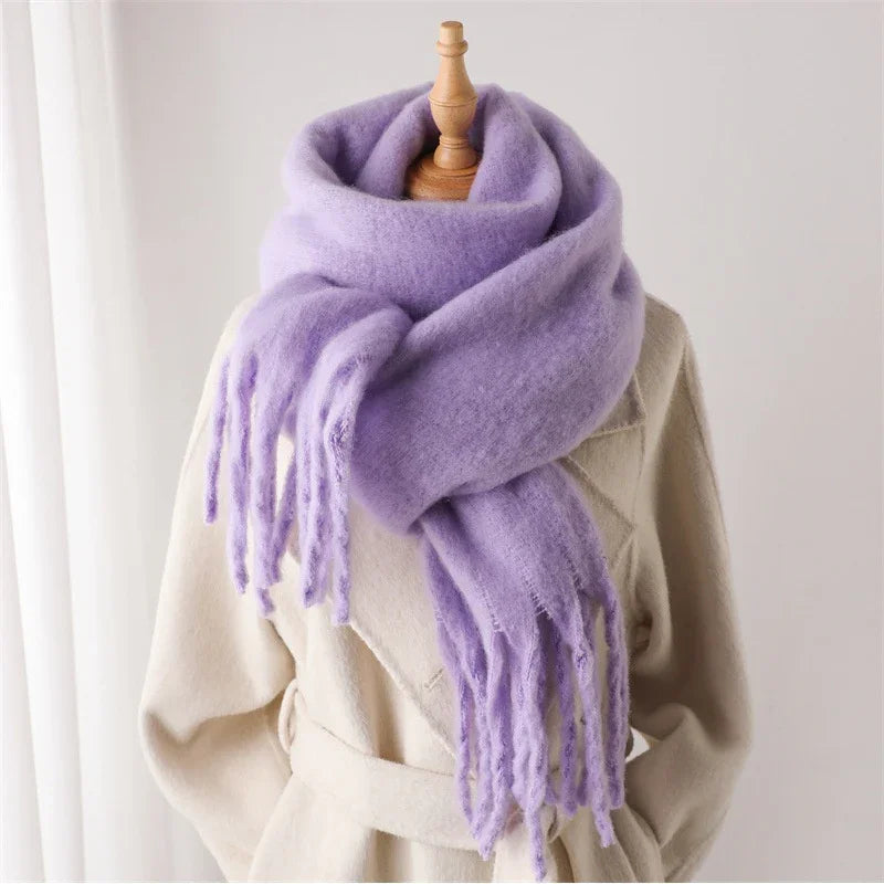Light purple wool scarf with fringes wrapped on cream belted coat on mannequin