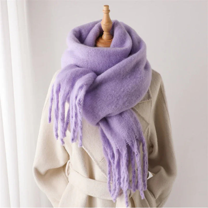 Light purple wool scarf with fringes wrapped on cream belted coat on mannequin