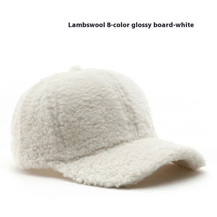 White lambswool textured baseball cap with curved brim on white background