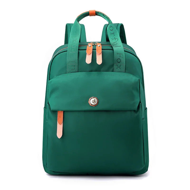 Green backpack with front pocket, brown zipper pulls, and green strap with 'Grateful Fox' text
