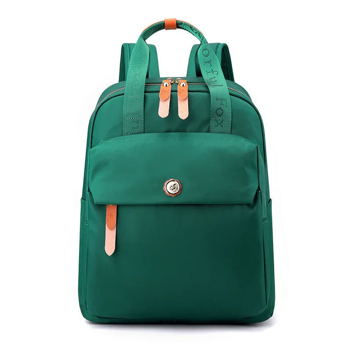 Green backpack with front pocket, brown zipper pulls, and green strap with 'Grateful Fox' text