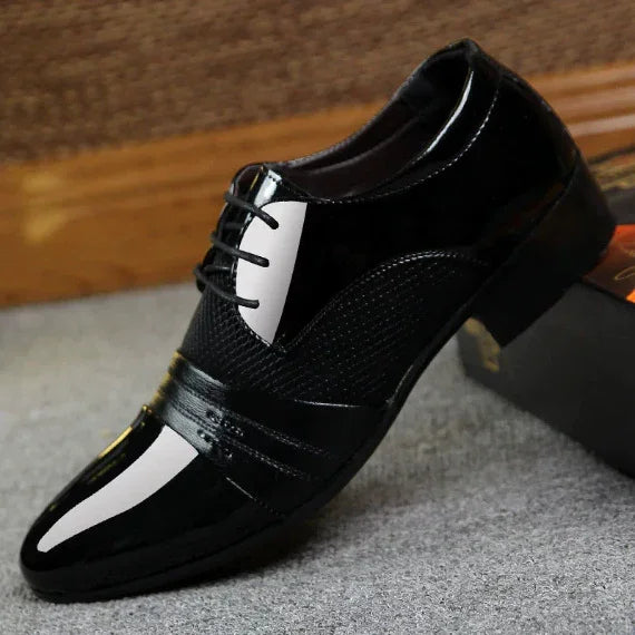 shiny black leather men's formal dress shoe with lace-up design on carpeted floor