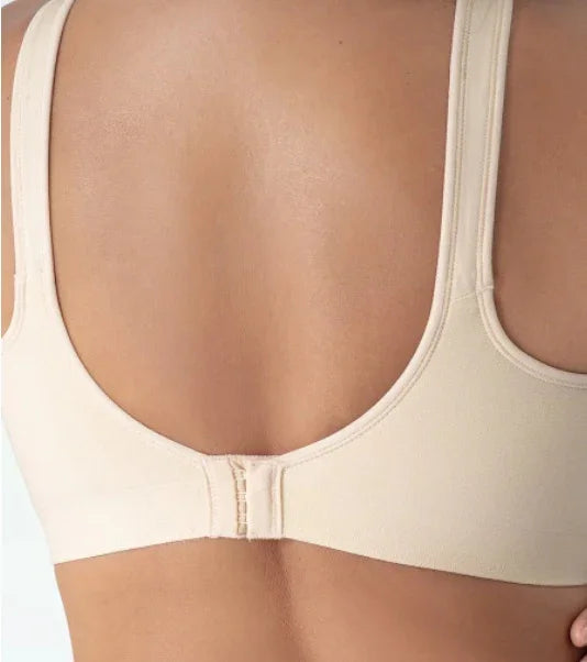 Close-up of woman's back wearing beige seamless bra with adjustable hooks and wide straps