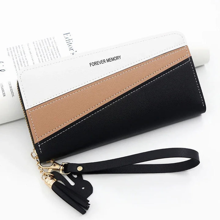 Tricolor leather wristlet wallet in white, brown, and black with tassel and 'FOREVER MEMORY' text