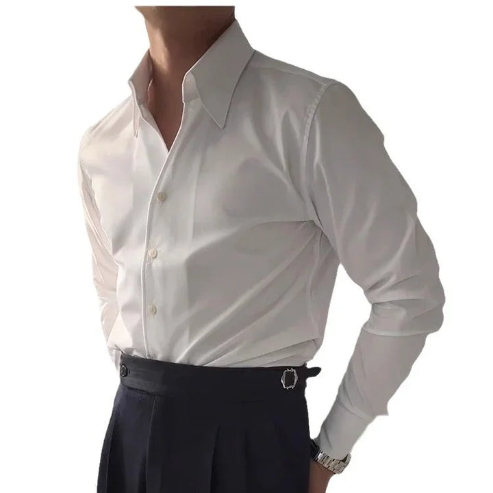 Close-up of man wearing white dress shirt tucked into high-waisted black trousers with silver buckle