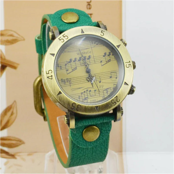 Vintage wristwatch with green leather strap and musical notes dial in brass case