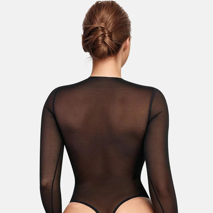 Back view of woman with braided bun wearing sheer black long-sleeve bodysuit on white background