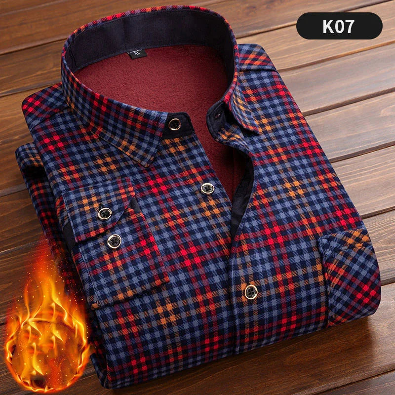 Warm flannel plaid shirt in red, blue, and orange tones folded on wooden surface