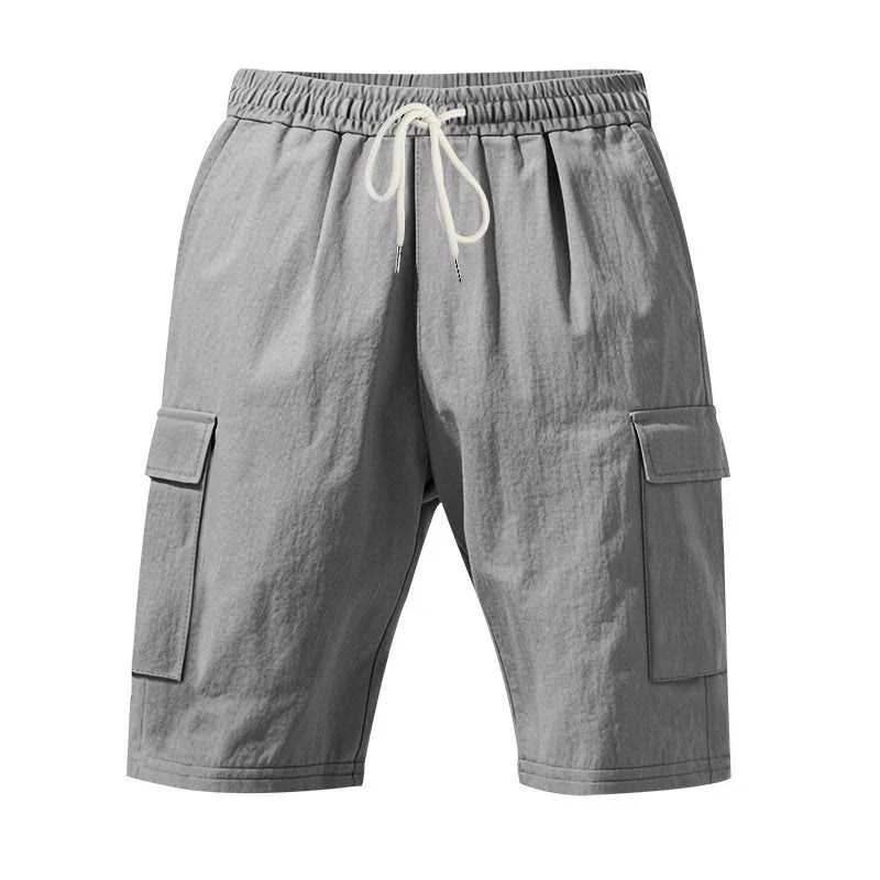 Gray cargo shorts with elastic waistband and white drawstring, featuring side flap pockets