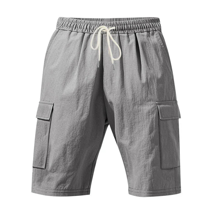 Gray cargo shorts with elastic waistband and white drawstring, featuring side flap pockets