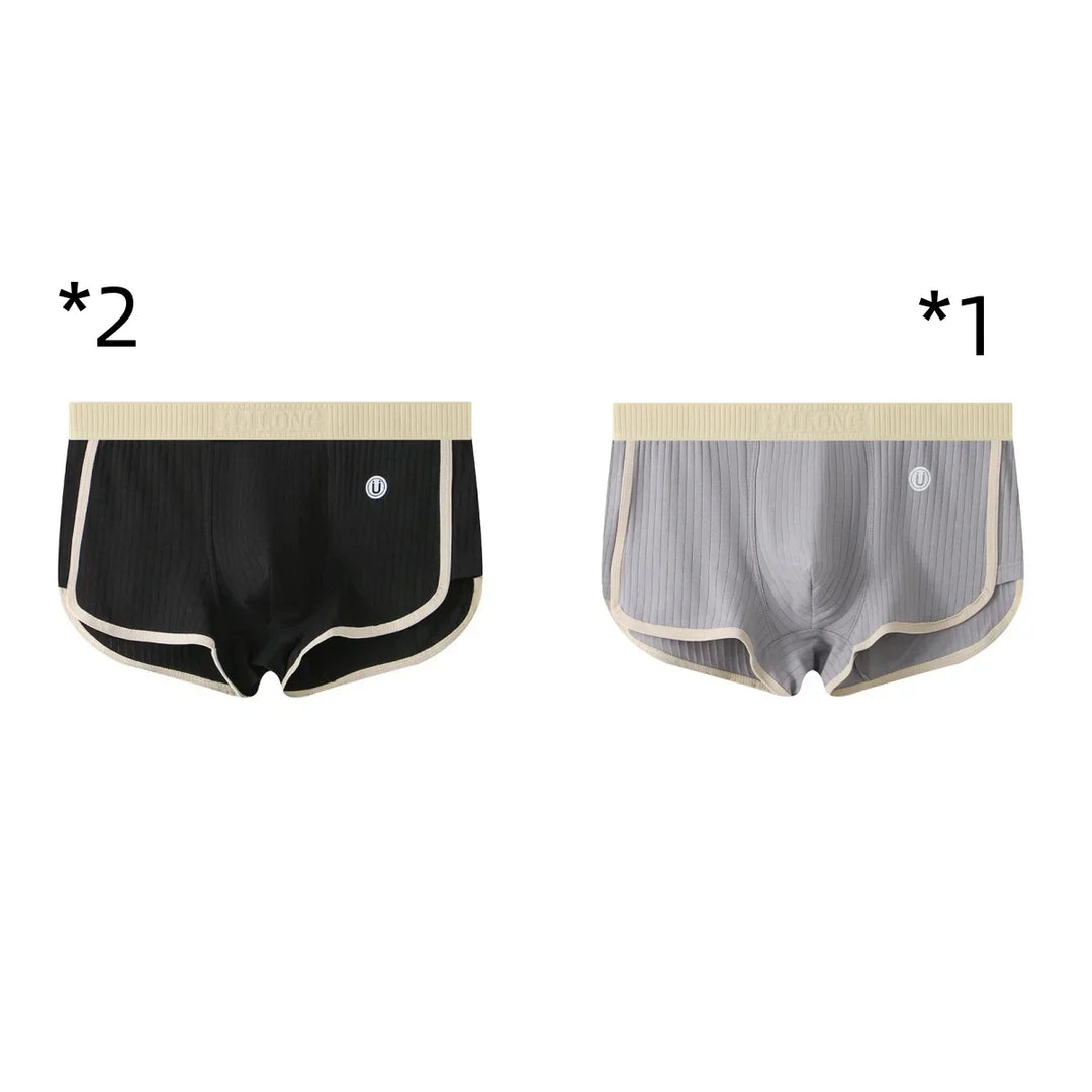 Two men's ribbed boxer briefs in black and gray with beige trim and waistband on white background