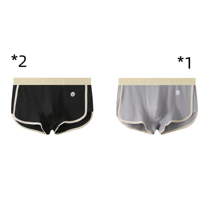 Two men's ribbed boxer briefs in black and gray with beige trim and waistband on white background