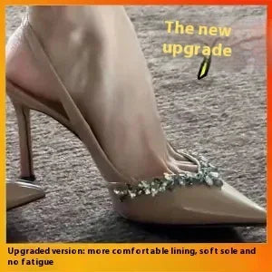 Close-up of nude high heel shoe with rhinestone ankle strap on carpet