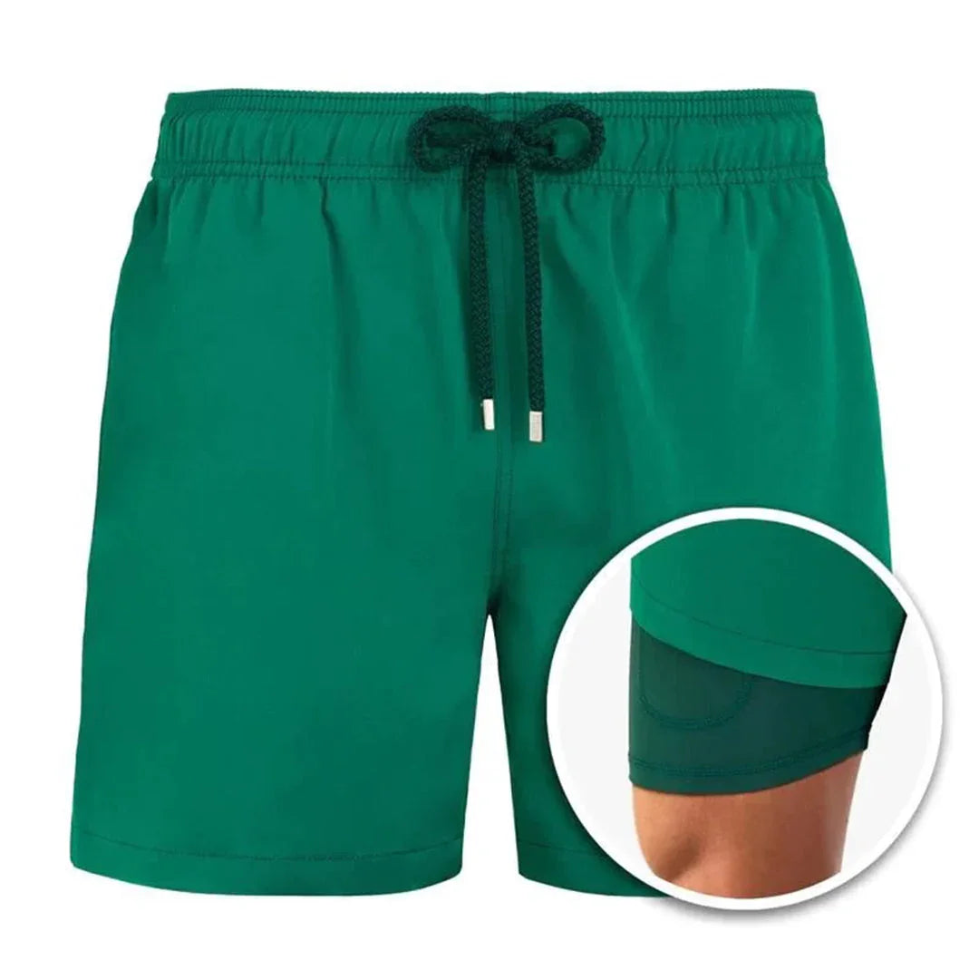 Green men's swim shorts with black drawstring and built-in inner compression liner
