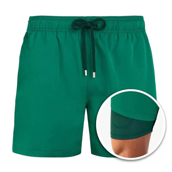 Green men's swim shorts with black drawstring and built-in inner compression liner